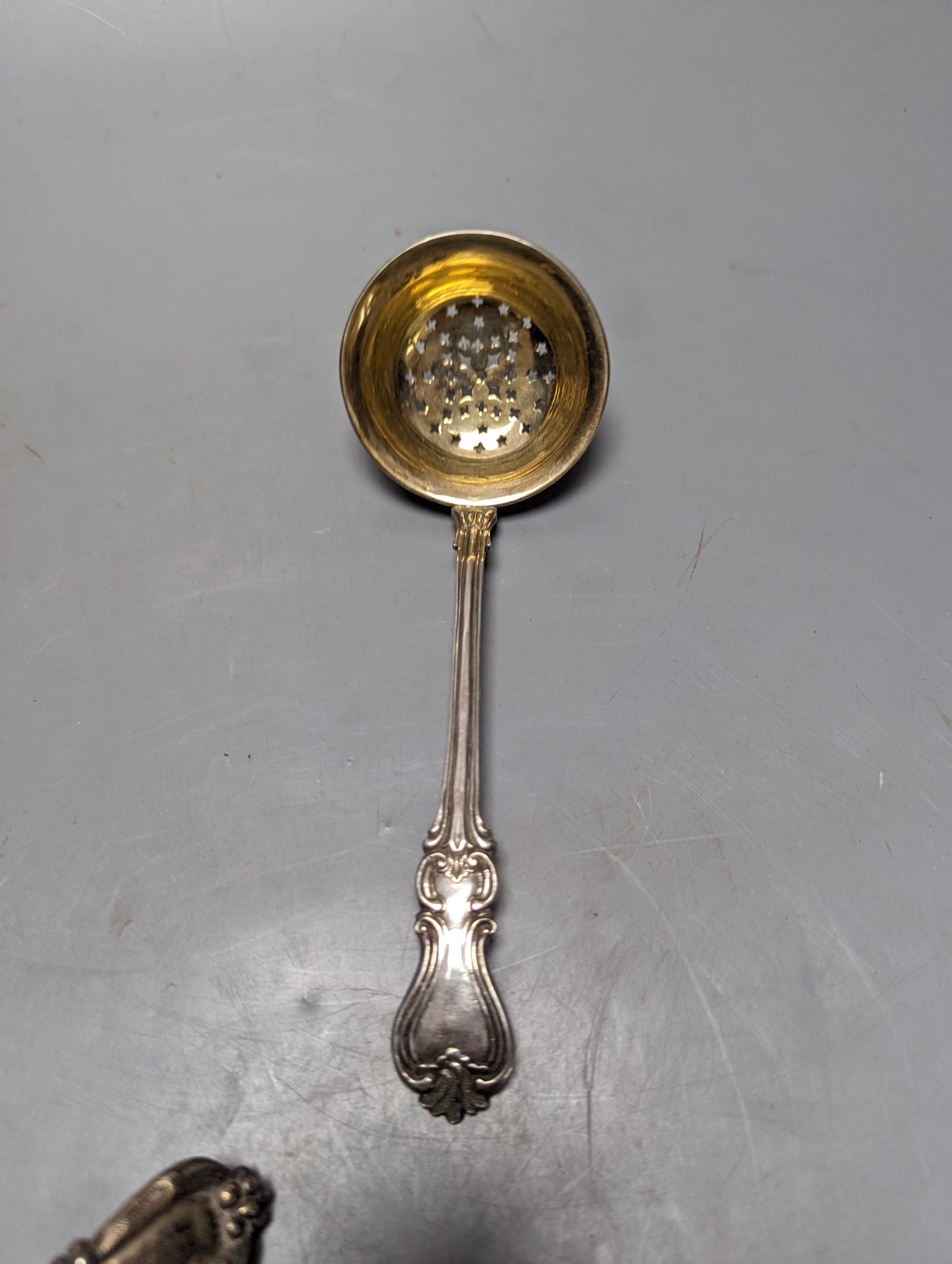 A late 19ty century Russian 84 zolotnik sifter ladle, assay master Ludvig Zug, 187?, 18.7cm, and a Victorian silver sifter spoon with vineous handle, 5oz.